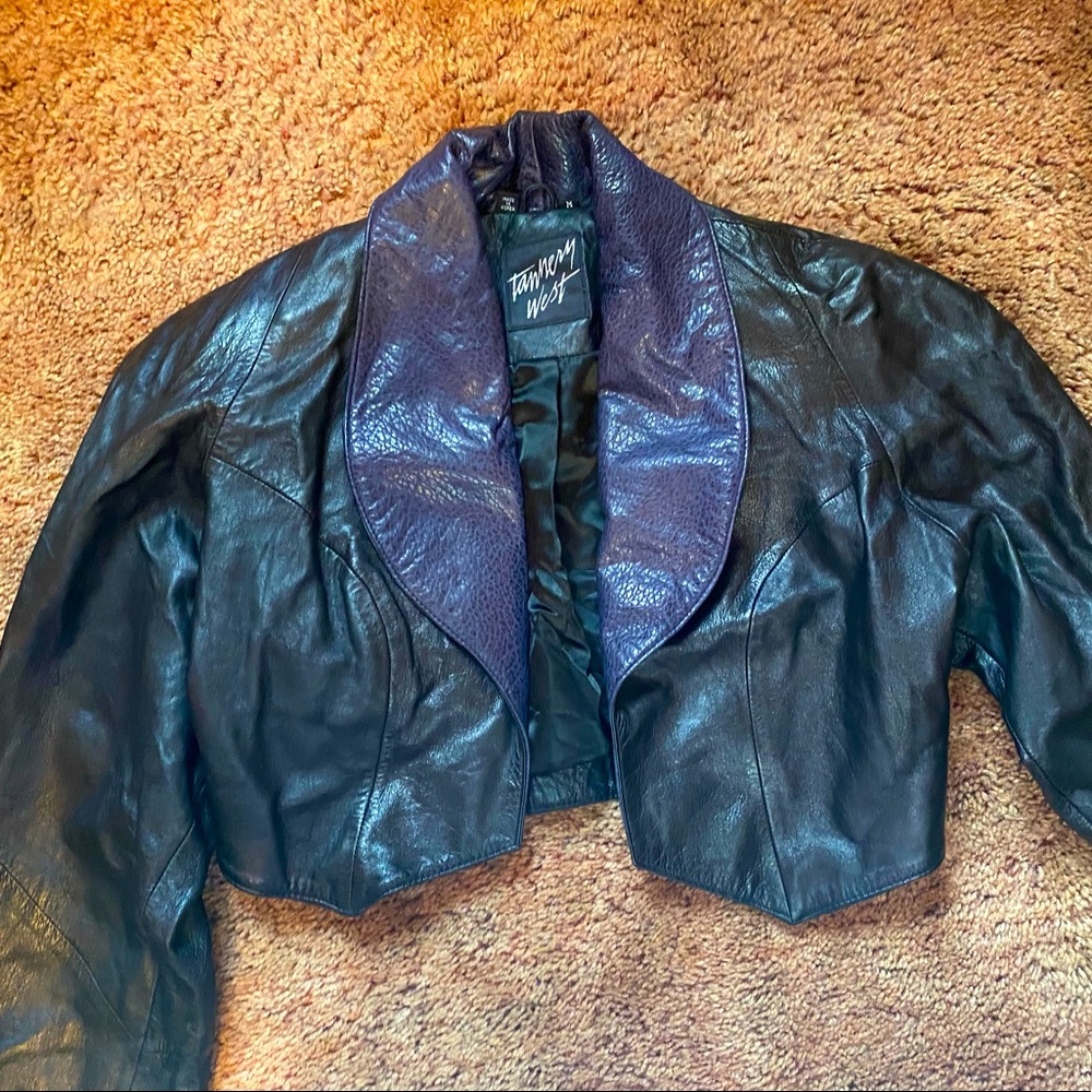 A real short Black Leather Jacket with A Printed collar it’s A Size Medium
